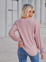 Blush pink eyelet blouse with lace trim cuffs and a relaxed fit.