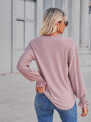 Blush pink eyelet blouse with lace trim cuffs and a relaxed fit.