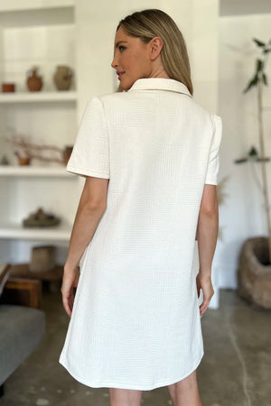 Textured ivory mini dress with short sleeves and a collared neckline.