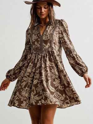 Brown floral print long sleeve mini dress with notched neckline and balloon sleeves.