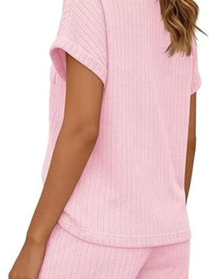 Pink ribbed knit loungewear set with short sleeves and drawstring shorts.