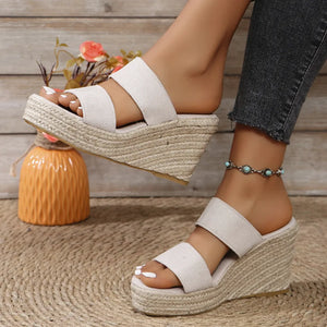 White rope-wrapped platform wedge slides with double straps and espadrille sole.