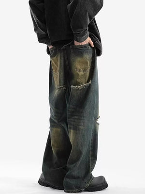 Men's vintage distressed wide-leg jeans in dark wash denim with ripped details.