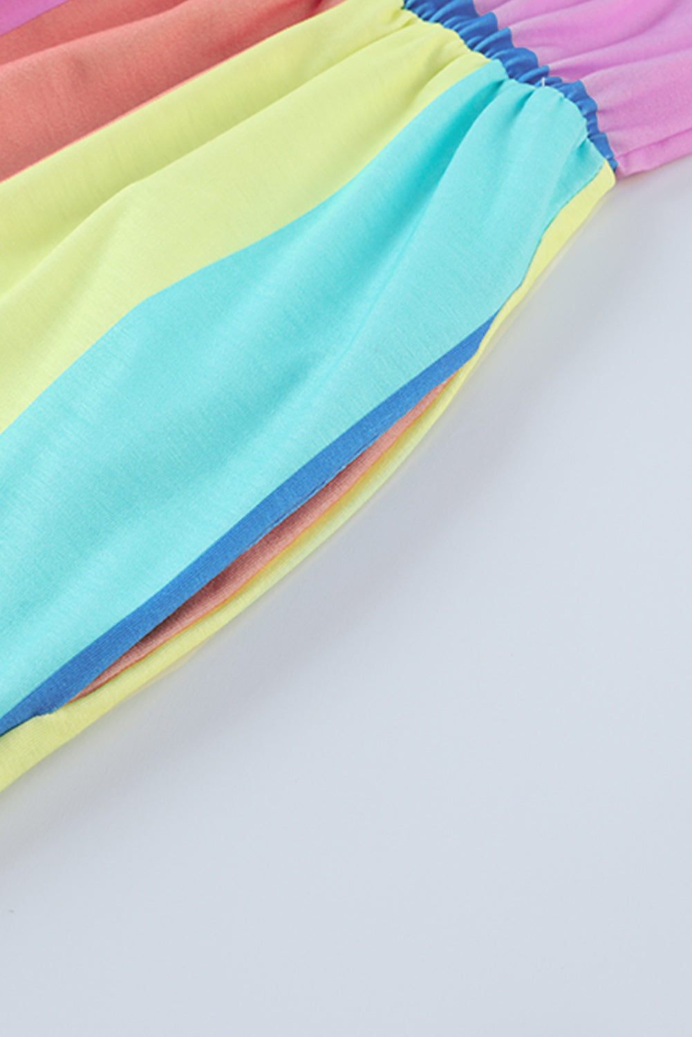 Rainbow stripe romper with elastic waist and pockets.