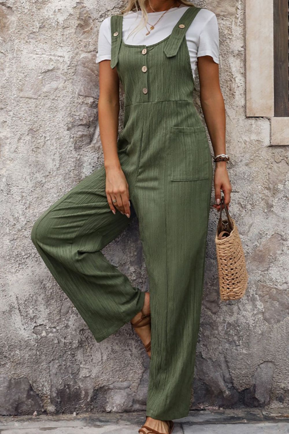 Textured linen button-front jumpsuit in matcha green with wide legs and pockets.