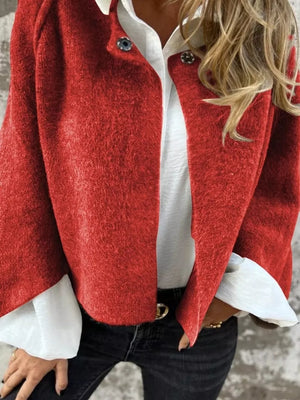 Red fuzzy knit cardigan with button detail, worn over a white shirt.