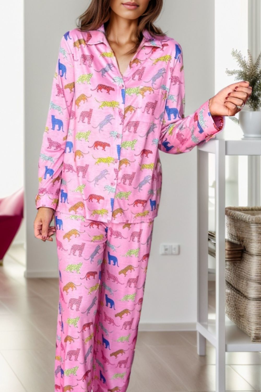 Pink leopard print pajama set with long sleeves and pants.