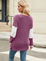 Ribbed knit henley sweater in plum with white colorblock sleeves and crew neck.