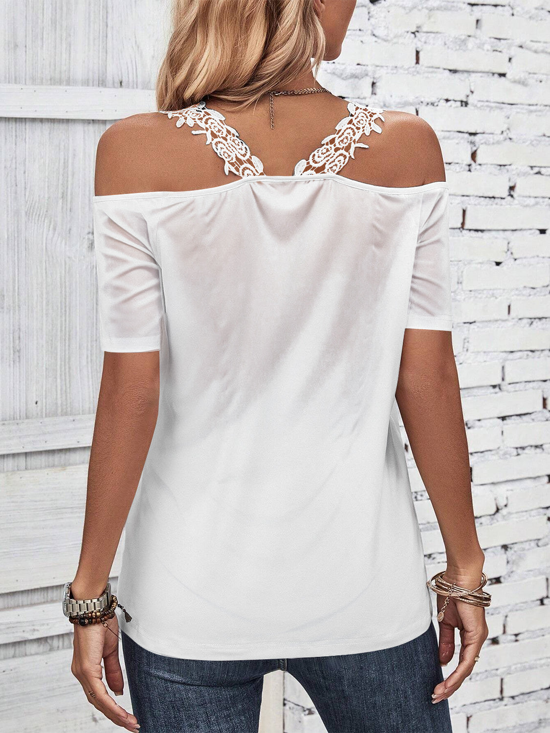 White off-the-shoulder blouse with lace yoke detail and short sleeves.