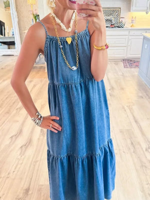 Blue denim tiered ruffle midi dress with spaghetti straps.