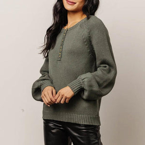 Army green acrylic knit henley sweater with balloon sleeves and button detail