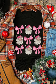 Black t-shirt with a repeating pattern of Santa Claus faces and pink bows.