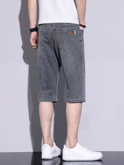 Men's grey washed denim shorts with button closure and classic five-pocket styling.