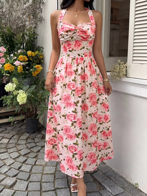 Pink floral halter midi dress with ruched bust and a-line skirt.