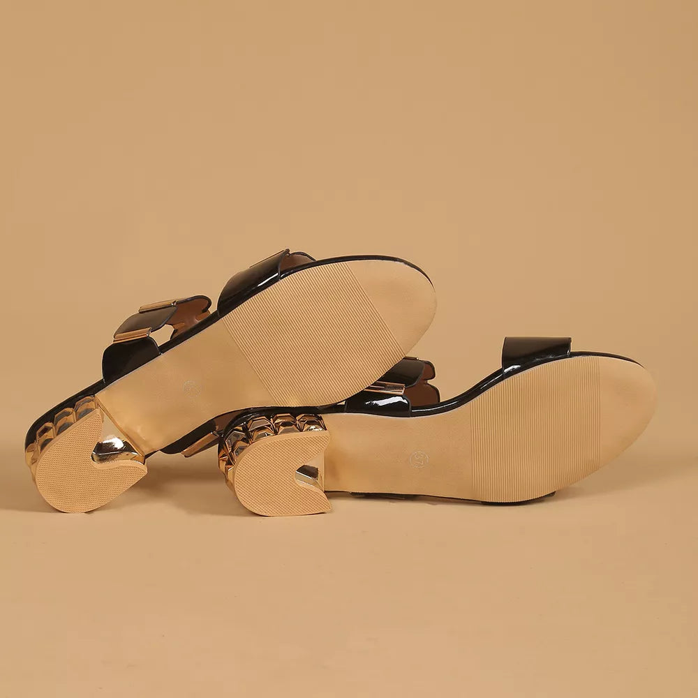 Black patent block heel sandals with gold accent details and textured heels.