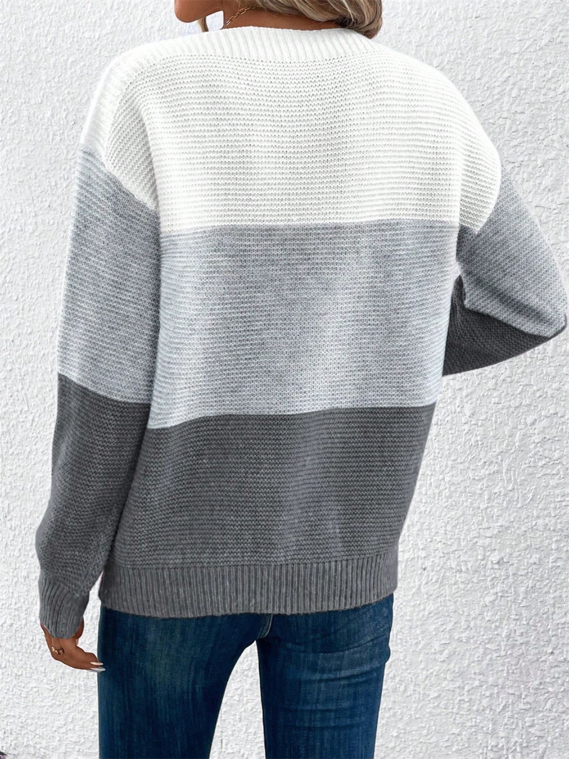 Colorblock boatneck knit sweater in gray and white acrylic with horizontal stripes.