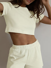 Cream waffle knit crop top with short sleeves and matching drawstring shorts.