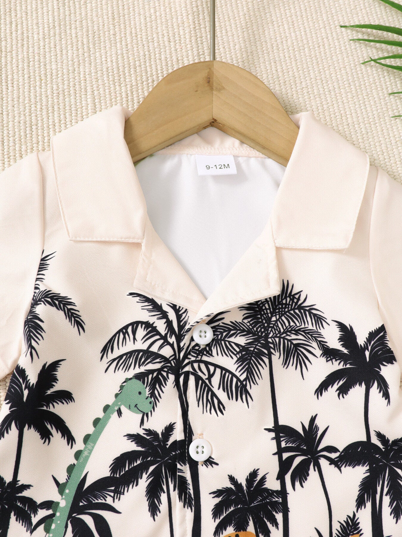 Baby boys' set with short-sleeve shirt featuring a dinosaur and palm tree print.