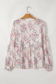 Floral peplum blouse with square neck and long sleeves.