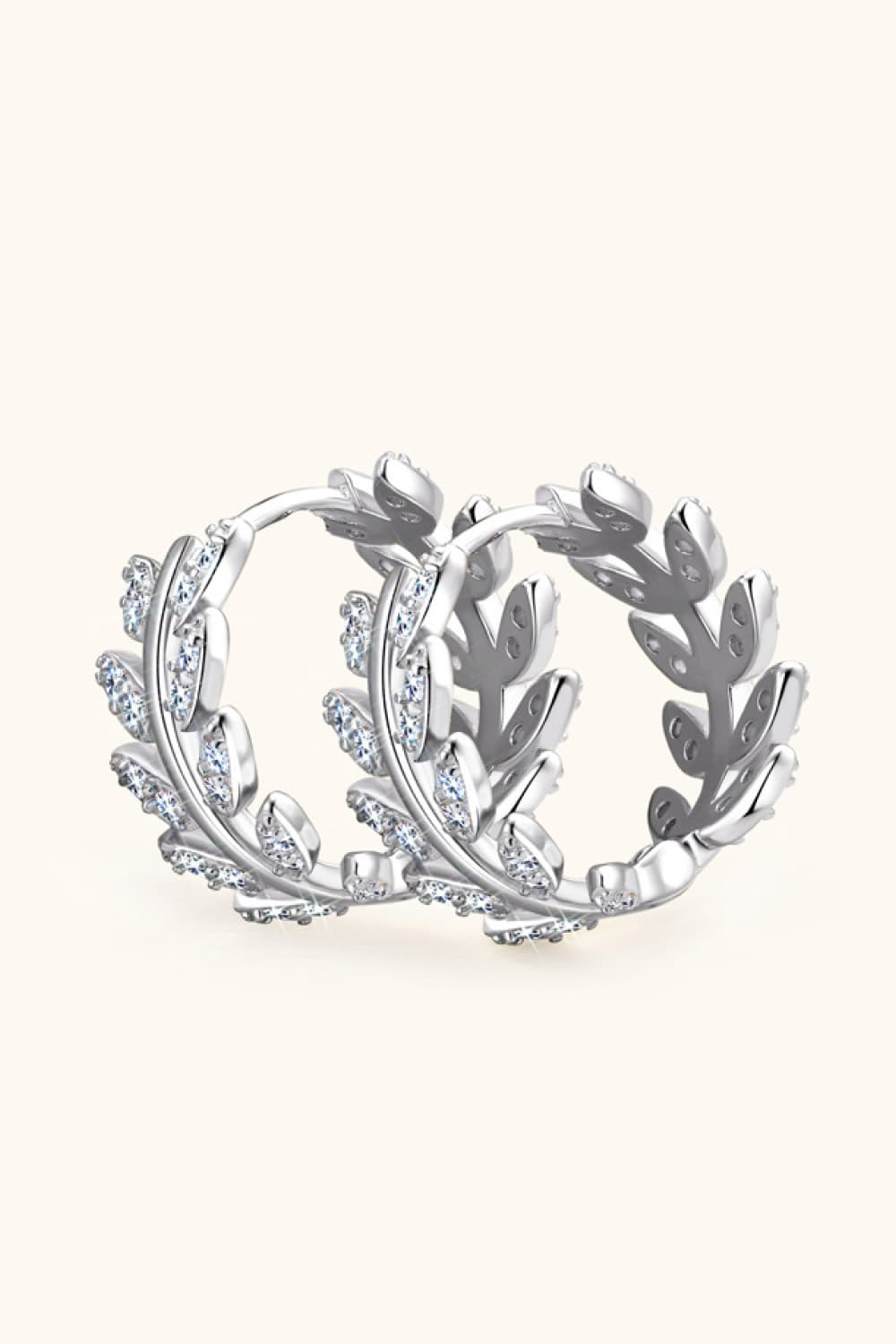 Silver leaf pavé hoop earrings with cubic zirconia accents, made of 925 sterling silver.