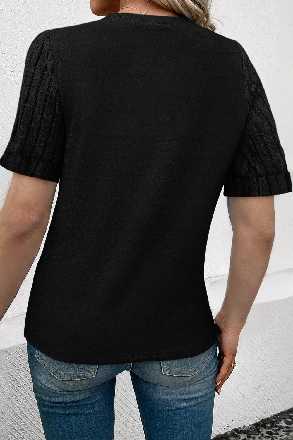 Black crew neck t-shirt with ribbed short sleeves and a crew neckline.