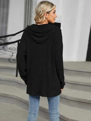 Black ribbed knit henley hoodie with a hood and button detail.
