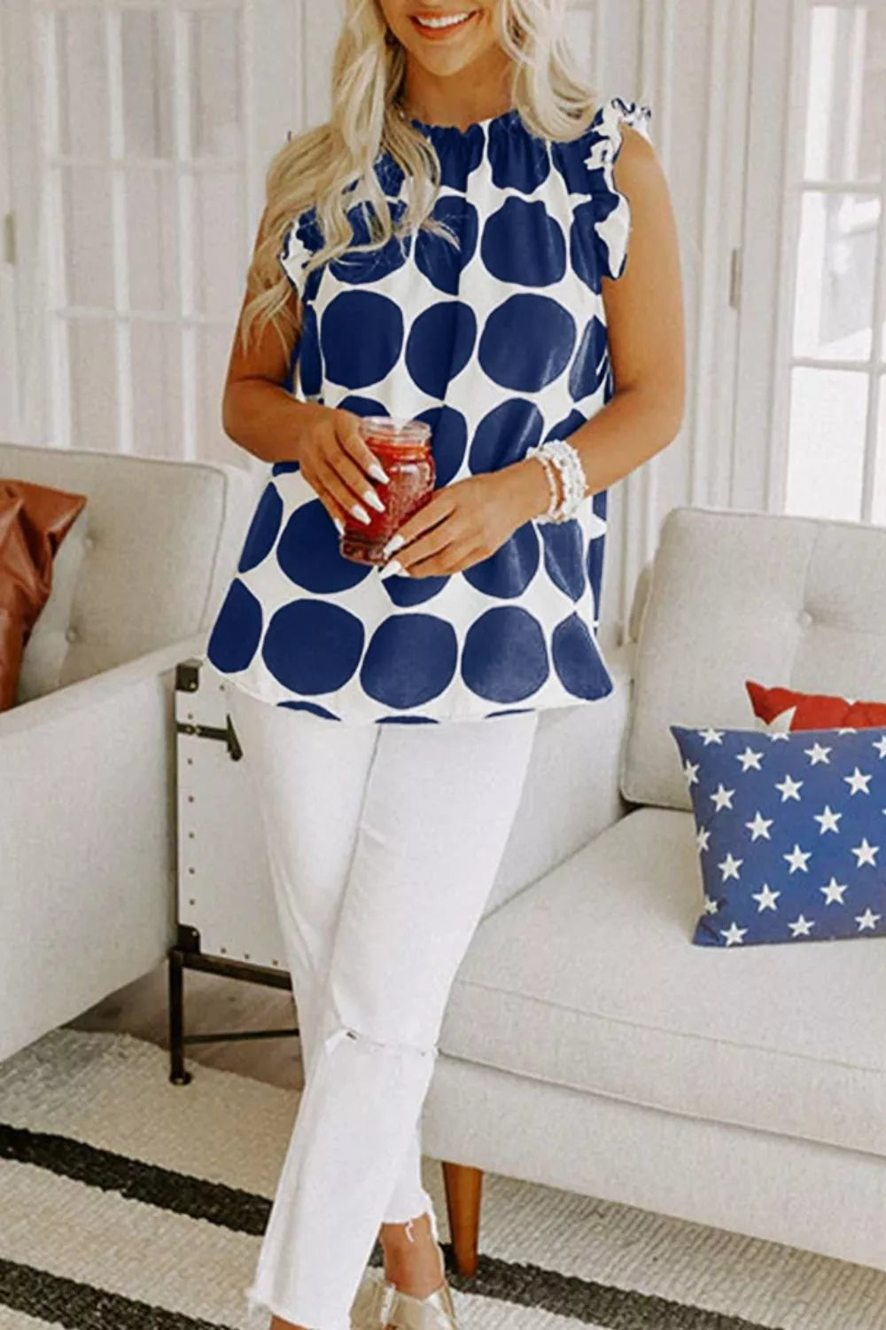 Navy and white polka dot cami with ruffled neckline and sleeves