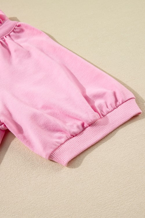 Pink cotton co-ord set with ruffled neckline detail and zip-up front.