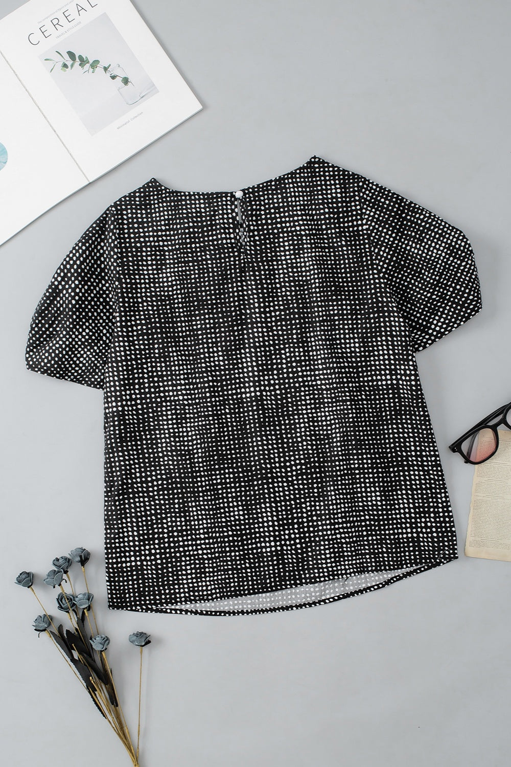 Black micro-dot puff sleeve blouse with round neckline and back keyhole closure.
