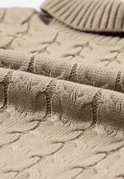 Khaki cable knit turtleneck capelet sweater with textured acrylic fabric.