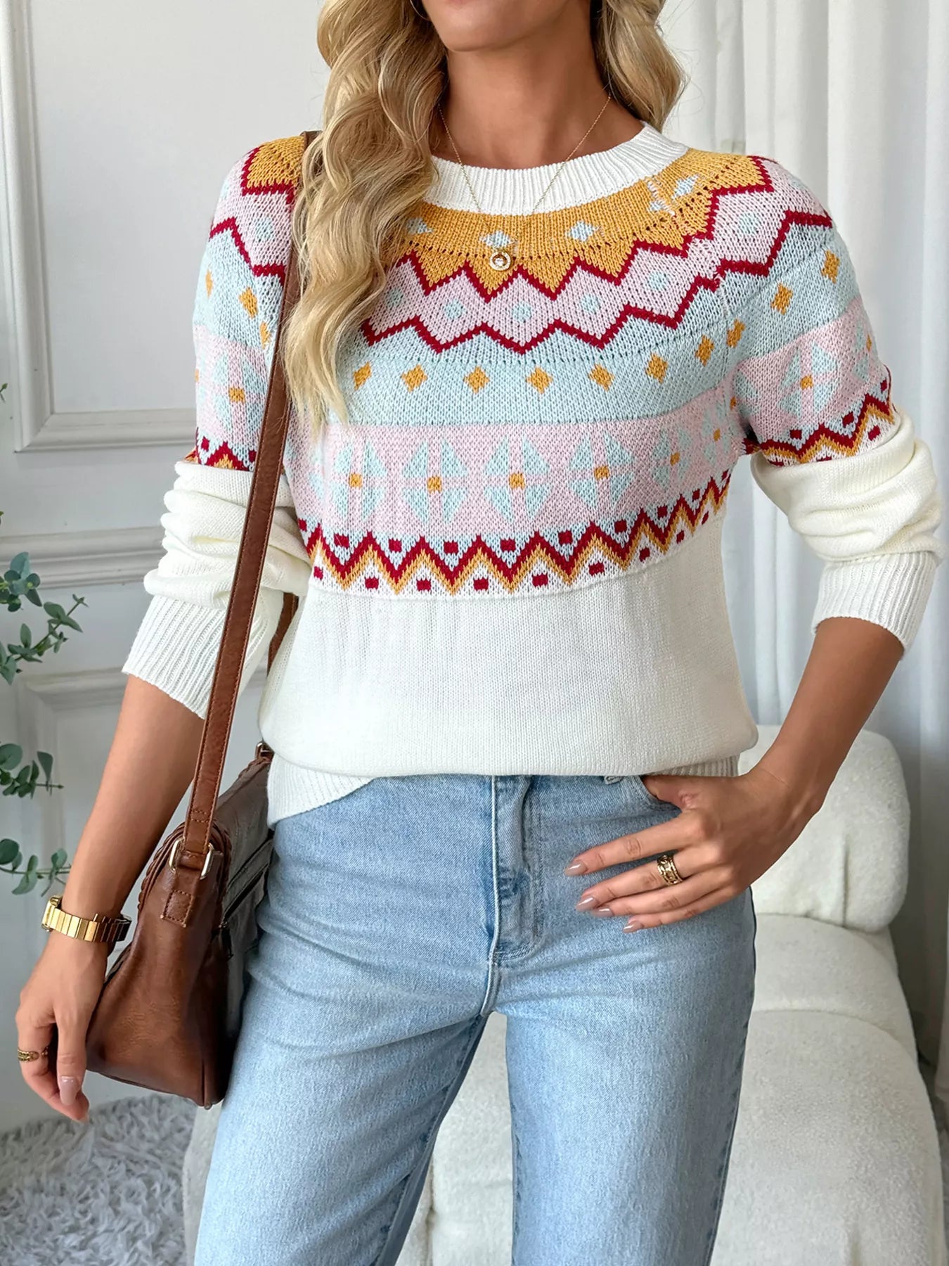 Geometric knit long-sleeve sweater in white with colorful fair isle pattern and crew neck.