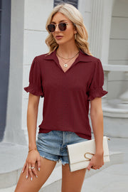 Burgundy eyelet polo blouse with short puff sleeves and ruffled cuffs.