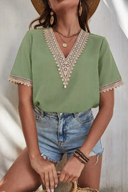 Light green short sleeve blouse with lace trim V-neck and cuffs