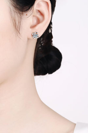 Silver four-leaf clover stud earrings with a central sparkling stone.