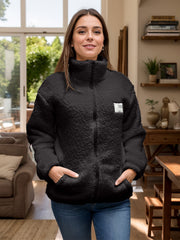 Black textured sherpa zip-up jacket with stand collar and patch detail