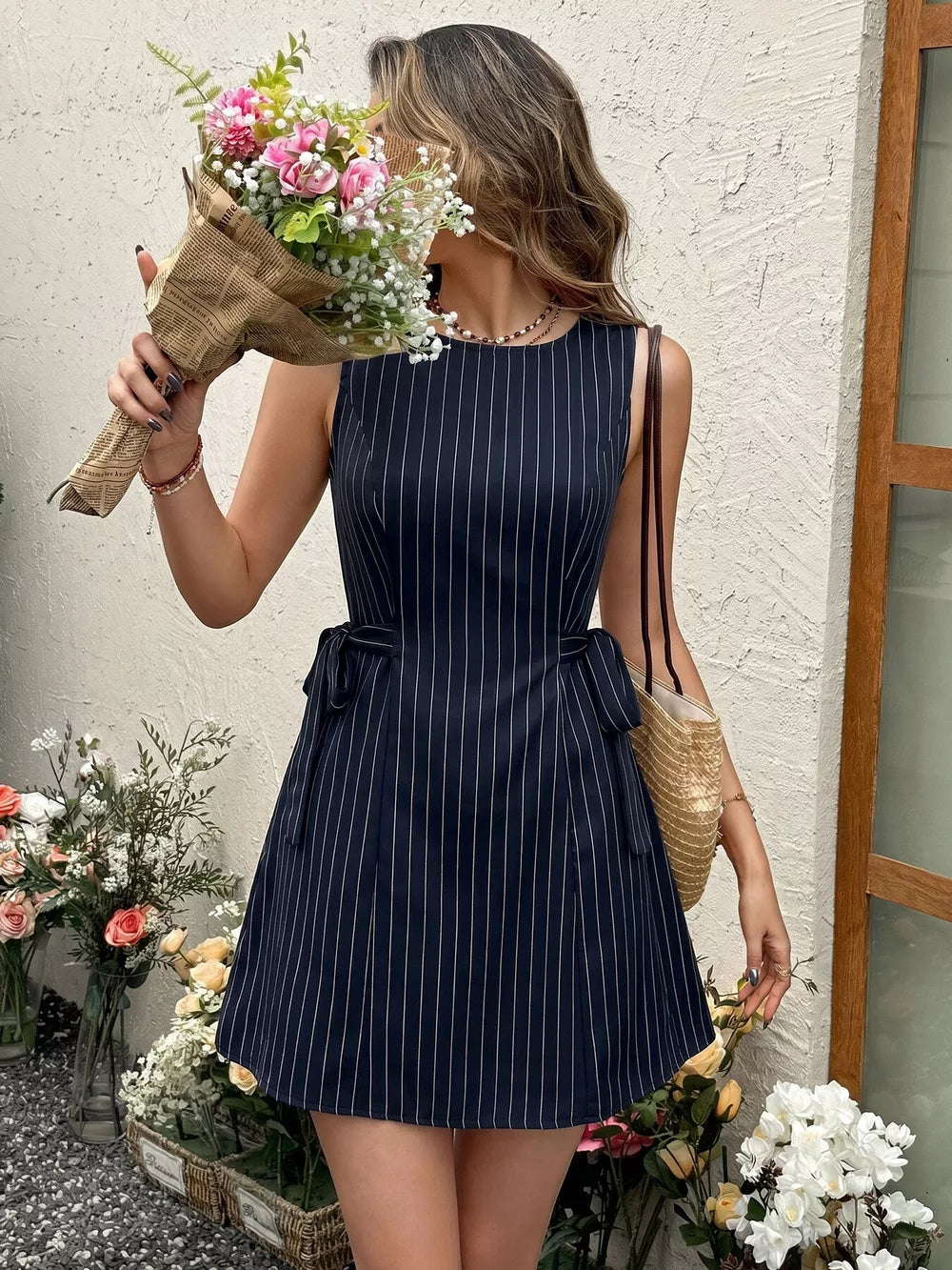 Navy striped tie-waist A-line dress with a sleeveless design and a short hem.