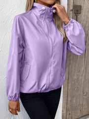 Lavender nylon bomber jacket with drawstring hem and zip front, styled casually.