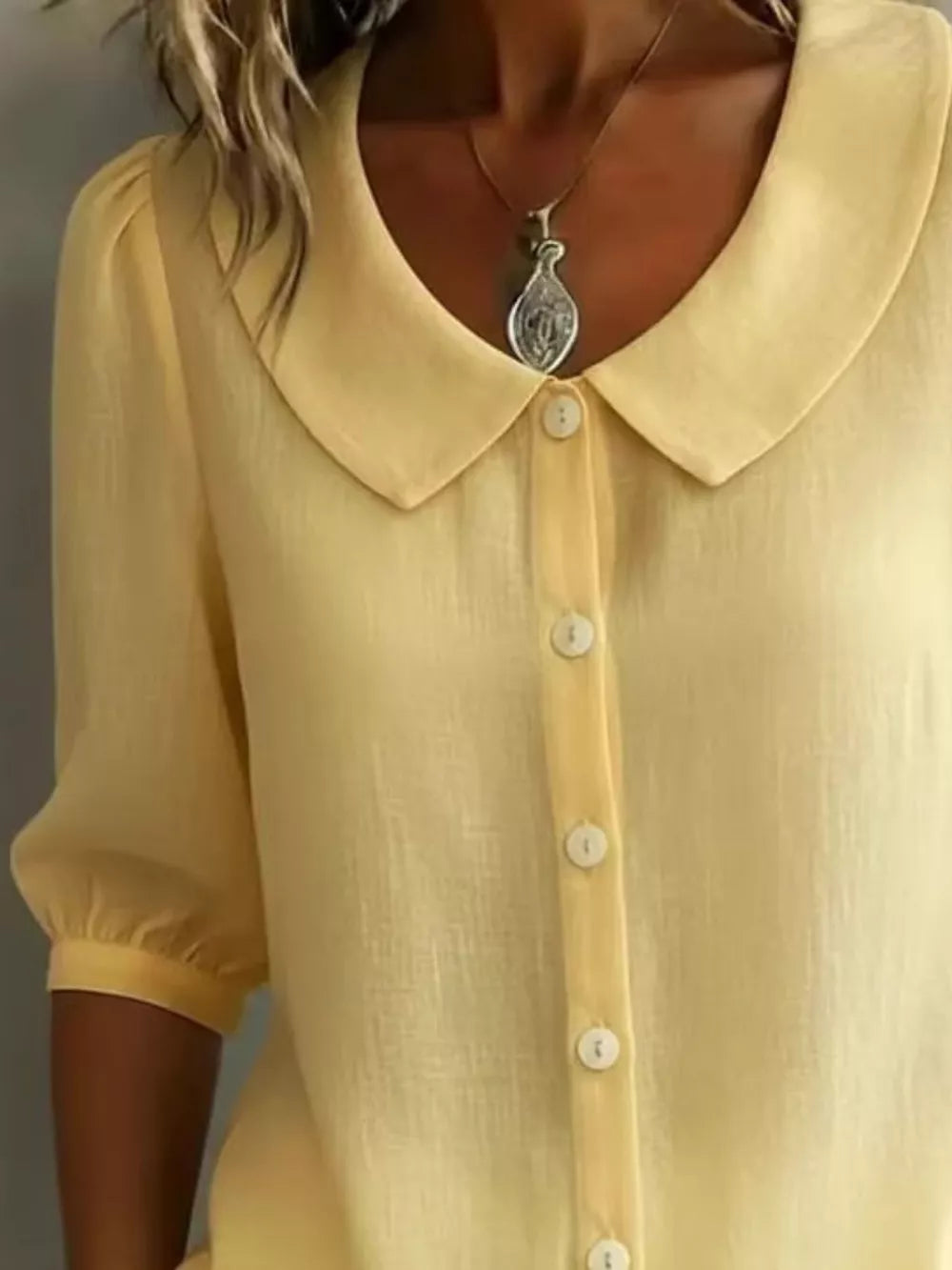Yellow linen-look button-down shirt with Peter Pan collar and puff sleeves.