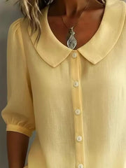 Yellow linen-look button-down shirt with Peter Pan collar and puff sleeves.