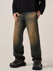 Men's relaxed fit jeans in vintage wash denim with distressed details.