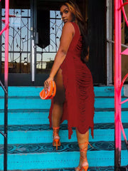 Red distressed fringe midi dress with square neck and high slit, worn with orange heels.