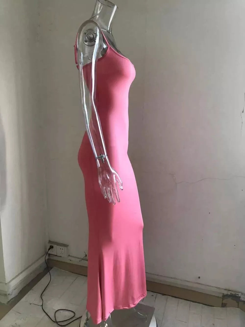 Spaghetti strap bodycon maxi dress in pink with a flared hem.