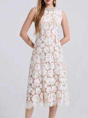 White lace dress with embellished neckline and scalloped hem.