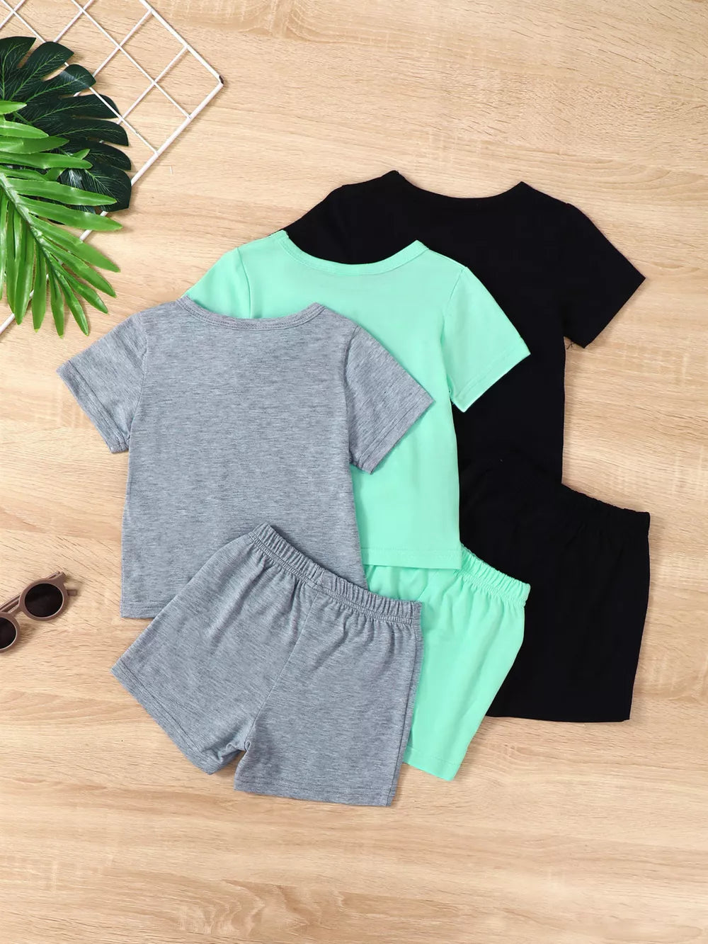 Boys' 4-piece underwear set with graphic tropical palm print, in black, mint green, and grey.