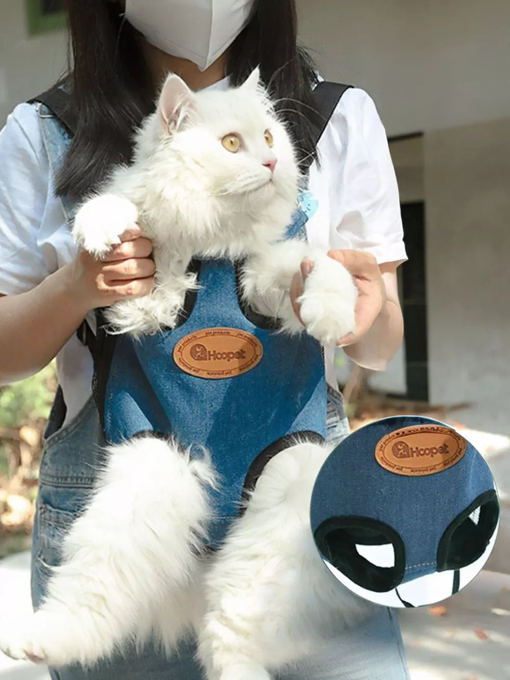 Blue denim-like pet carrier backpack with adjustable straps and leg openings.