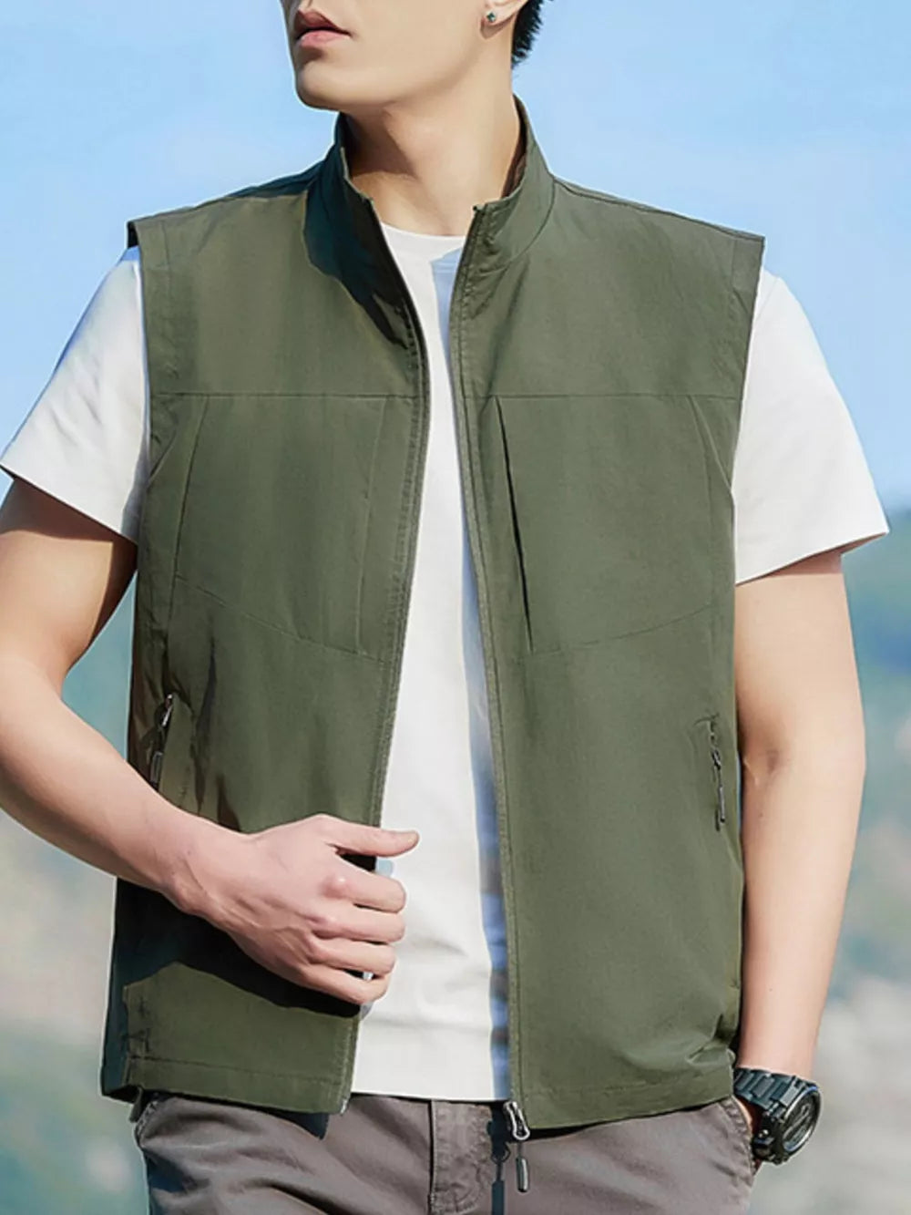 Men's Matcha Green zip up vest with stand collar and zippered pockets.