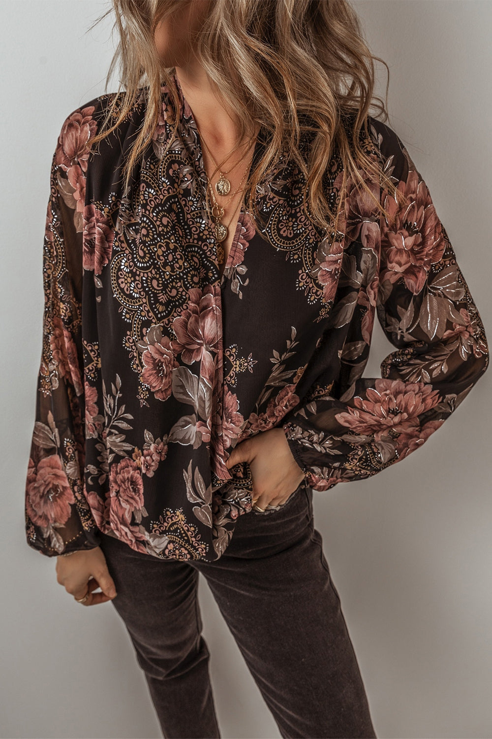 Black floral print blouson sleeve surplice top with sheer sleeves.