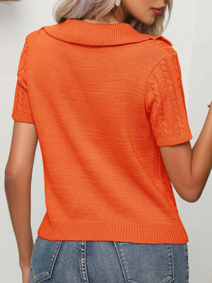 Orange knit short sleeve polo sweater with cable knit sleeves and collar.