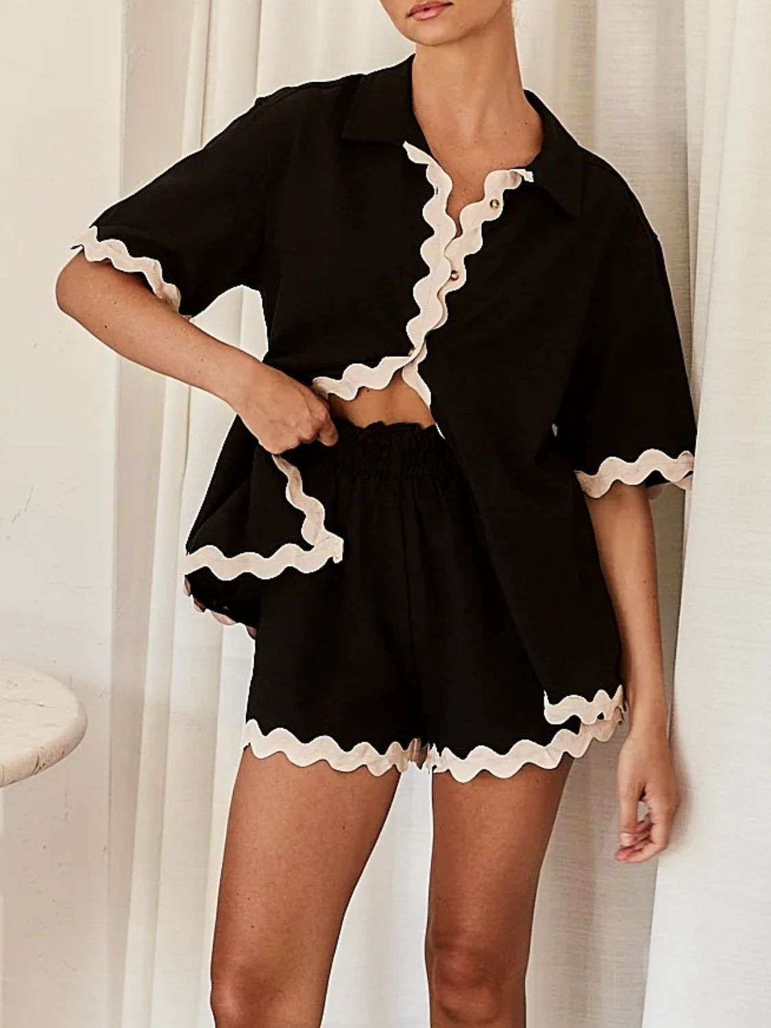 Black loungewear set with scalloped edges on shirt and shorts