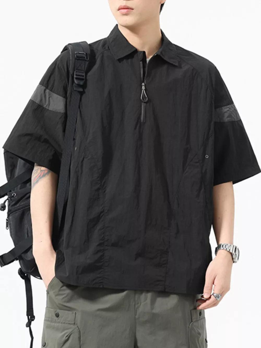 Black quarter-zip polo shirt with short sleeves, contrasting arm bands, and a chest pocket.